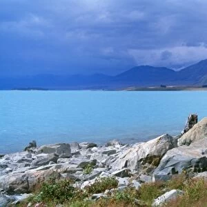 New Zealand - The intense blue of the water is due to the presence of Limestone. Evidence of this is clear by rocks at the shoreline. Lake Tekapo, South Island