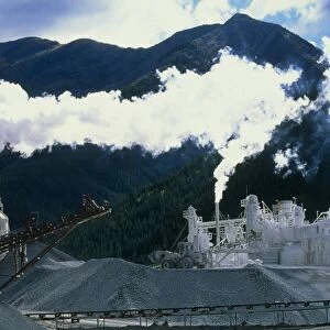 Cement works with smoke coming from its chimneys