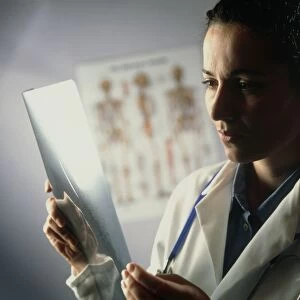 Female doctor studying an X-ray image