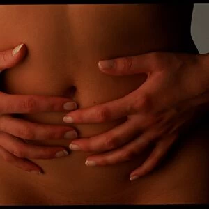 Menstrual pain: womans hands holding her abdomen