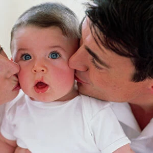 Parents kissing baby boy