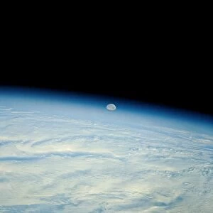 Shuttle photograph of the moon over the earth