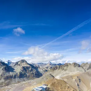 Aerial by drone of clear sky over Piz Nair and cable car station on top, Engadine