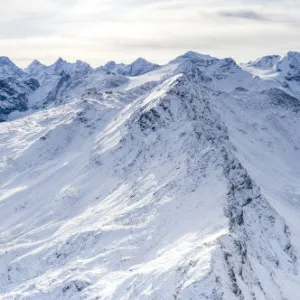 Aerial view by drone of Stelvio Pass road and snowy Ortles mountain, Sondrio province