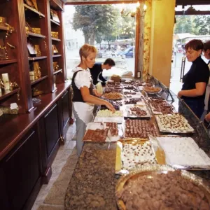AJ Sokoladas Print: Vilnius Street Scene with Chocolate Shop AJ Sokoladas Print: Vilnius Street Scene with Chocolate Shop