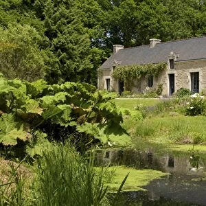 Ancient farm house and pond, granite walls and slate roof, Bubry village