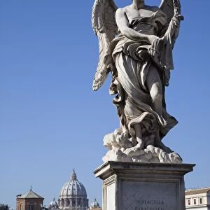 Angel statue on Ponte Sant Angelo (Bridge of Angels), with the dome of the Vatican in distance