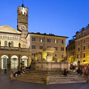 Baroque fountain and Santa Maria in Trastevere at night, Piazza Santa Maria in Trastevere