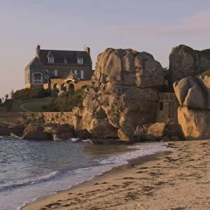 Beach house built behind rocks, Tregastel, Cote de Granit Rose, Cotes d Armor