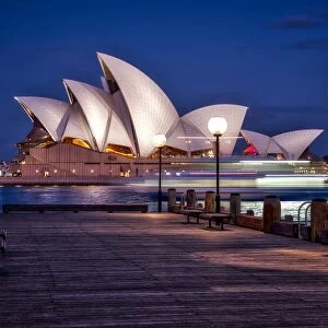 A boat passes by the Sydney Opera House, UNESCO World Heritage Site, during blue hour