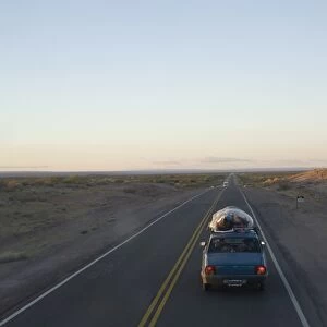 Car driving through the Pampa, Argentina, South America