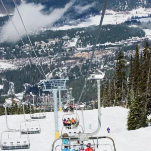 Chairlift with skiers, Whistler mountain resort, venue of the 2010 Winter Olympic Games