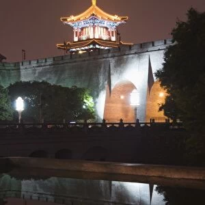 City wall and watch tower reflected in water, built during the first reign of Hongwu the first emperor of the Ming dynasty, Xian City, Shaanxi Province