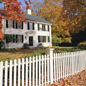 Clapperboard houses and fence in autumn