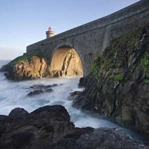 Cliffs and the bridge that lead to the Petit Minou lighthouse with side light at sunset, Finistere, Brittany, France, Europe