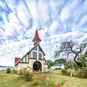 Clouds over the red roof of Notre Dame Auxiliatrice Church, Cap Malheureux, Mauritius