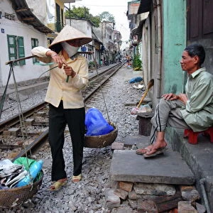 Daily life by the railway tracks in central Hanoi