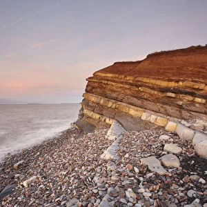 Evening light on rocks and the cliff at Kilve beach, Kilve, near Nether Stowey, Somerset