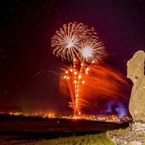 Fireworks ring in the New Year from the town of Hanga Roa over moai in the Tahai Archaeological Zone on Easter Island (Isla de Pascua) (Rapa Nui), UNESCO World Heritage Site, Chile, South America