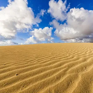 Fluffy clouds over desert sand dunes modeled by wind, Corralejo Natural Park, Fuerteventura, Canary Islands, Spain, Atlantic, Europe