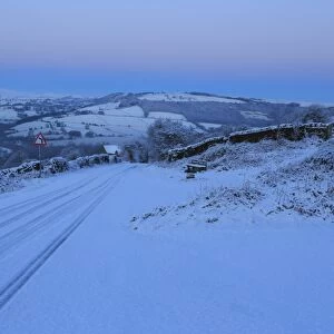 Fresh snow on country lane, winter pre-dawn blue hour, below Curbar Edge, Peak District National Park, Derbyshire, England, United Kingdom, Europe