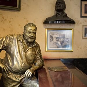 Lifesize bronze of the late author Ernest Hemingway at the bar of El Floridita, one of his favourite haunts, Havana, Cuba, West Indies, Central America