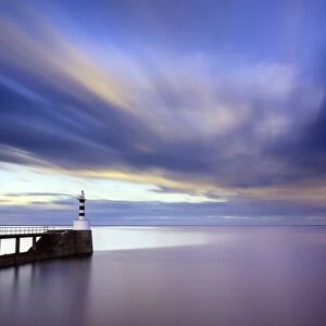 Long exposure image of Amble Lighthouse with streaky clouds and smooth sea, Amble