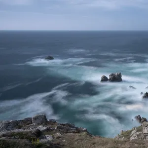 Long exposure on water with cliffs and many rocks, France, Europe