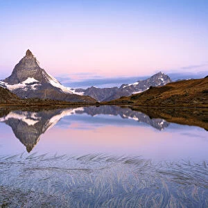 Matterhorn reflected in Riffelsee lake at dawn, Gornergrat, Zermatt, canton of Valais