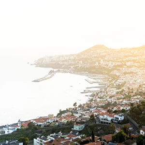 Mist at sunset over Funchal Bay and city viewed from Sao Goncalo, Madeira island