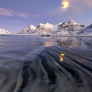 Full moon reflected in the icy sea around the surreal Skagsanden beach, Flakstad