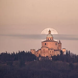 Full moon and a small cloud behind San Luca church (Madonna di San Luca)