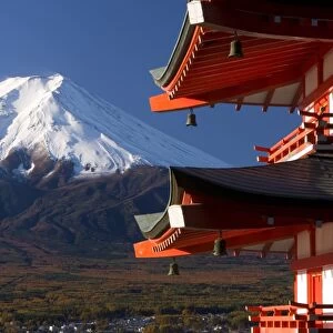 Mount Fuji capped in snow and the upper levels of a temple