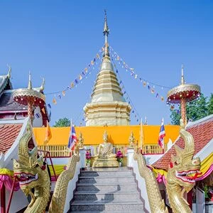 Naga head staircase and devotee at Doi Kham (Wat Phra That Doi Kham) (Temple of the