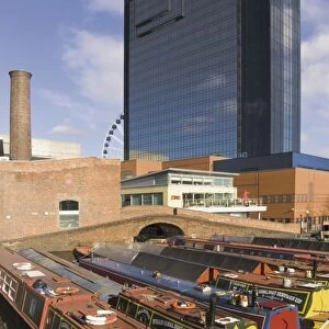 Narrow boats and barges moored at Gas Street Canal Basin, with Hyatt Hotel behind