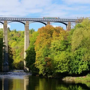 Narrowboat crossing the River Dee in autumn on the Pontcysyllte Aqueduct, built by Thomas Telford