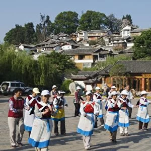 Naxi women dancing in Lijiang Old Town, UNESCO World Heritage Site, Yunnan Province