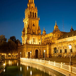The North Tower of Plaza de Espana lit up at night, Parque de Maria Luisa, Seville