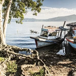 Old rusty fishing boats in a village at Lake Toba (Danau Toba), North Sumatra, Indonesia