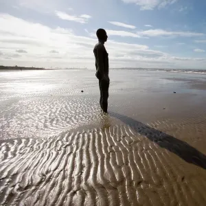 Another Place sculpture by Antony Gormley on the beach at Crosby, Liverpool