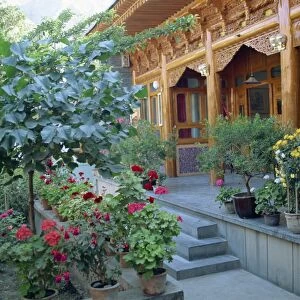 Pot plants, garden, and wooden Sala architecture in the north east of Qinghai