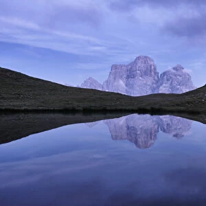 Reflection of Pelmo mountain in the Baste lake during blue hour, Dolomites