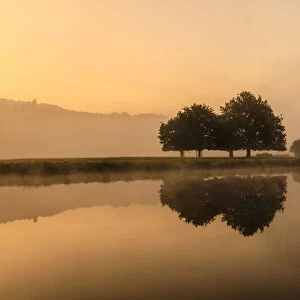 Reflections in River Derwent, dawn and autumn mist, Chatsworth Park, Peak District National Park