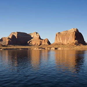 Sandstone cliffs reflected in the tranquil waters of Lake Powell
