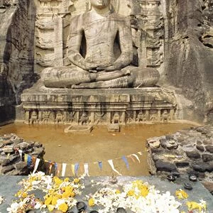 Seated Buddha statue with offerings