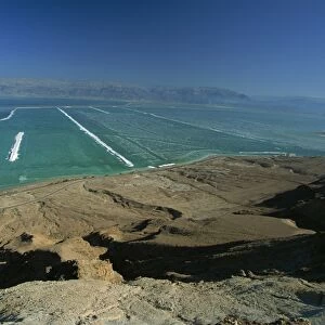 The shallow south end of the Dead Sea where salt deposits left by massive evaporation are mined