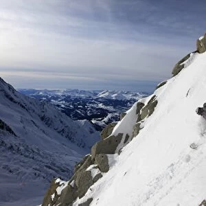 A snowboarder tackles a challenging off piste descent on Mont Blanc, Chamonix