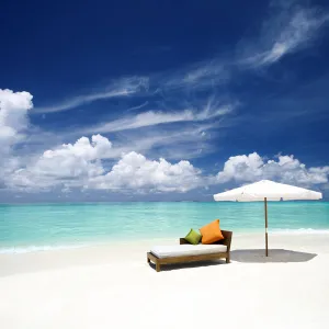 Sofa and parasol on tropical beach, The Maldives, Indian Ocean, Asia