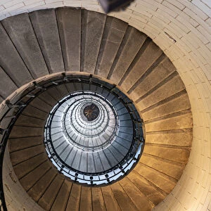 Spiral staircase from below in the Eckmuhl Lighthouse in Brittany, France, Europe