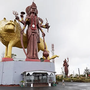 Statue of the Hindu goddess Durga, 108 feet tall, with her lion vehicle Manastala, at Ganga Talao, Mauritius, Indian Ocean, Africa